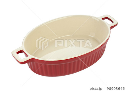 Red ceramic baking dish on a white background. Empty oval baking dish for gratin. 98903646