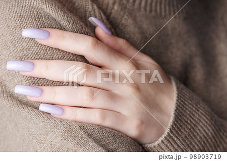 Girl's hands with a soft purple manicure. 98903719