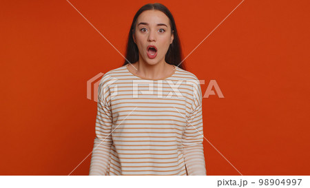 Excited amazed woman surprise looking at camera with big eyes, shocked by sudden victory wow emotion 98904997