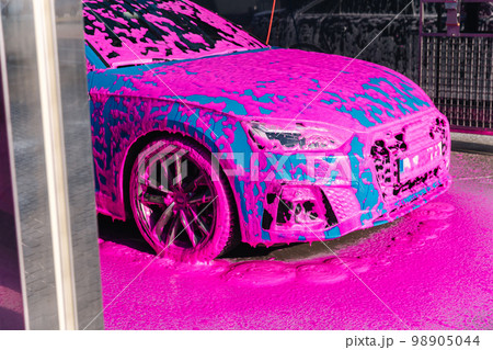 Luxury sport blue car on self servise car washing. Pink foam on auto Luxury sport blue car on self servise car washing. Pink foam on auto 98905044