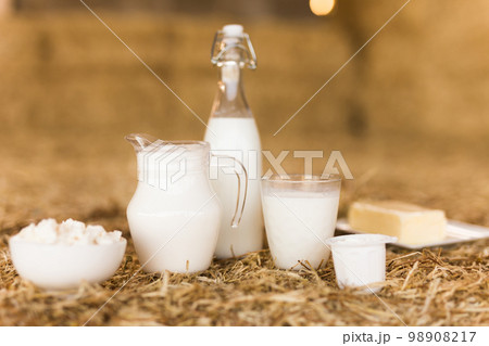 milk, cottage cheese, cream, cheese on table against the background of hay milk, cottage cheese, cream, cheese on table against the background of hay 98908217