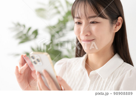 スマートフォンとカードを持つ女性 98908889