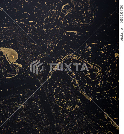 Abstract background with gold and black paint streaks 98910706