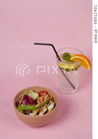 breakfast on table, rice with vegetables and drink, side view, monochromatic delicate background breakfast on table, rice with vegetables and drink, side view, monochromatic delicate background 98912401