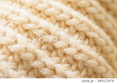 closeup beige knitted woolen fabric texture background 98912978