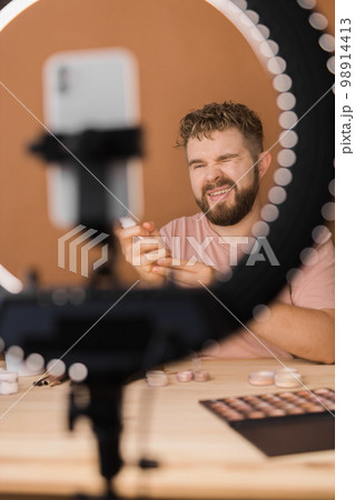 Bearded man professional beauty make up artist vlogger or blogger recording makeup tutorial to share on website or social media. 98914413