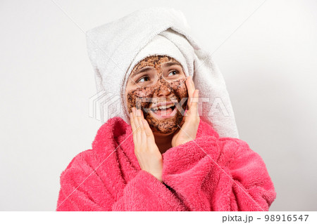 A woman with a mask on her face with her mouth open looks away, allergic to the composition of cosmetics for facial care 98916547