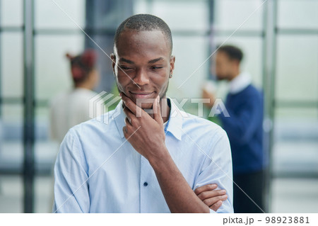 Young handsome african american man in casual shirt standing Young handsome african american man in casual shirt standing 98923881