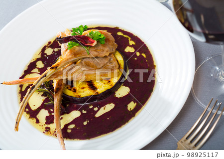 Baked lamb ribs in wine sauce with eggplant and dried hibiscus Baked lamb ribs in wine sauce with eggplant and dried hibiscus 98925117