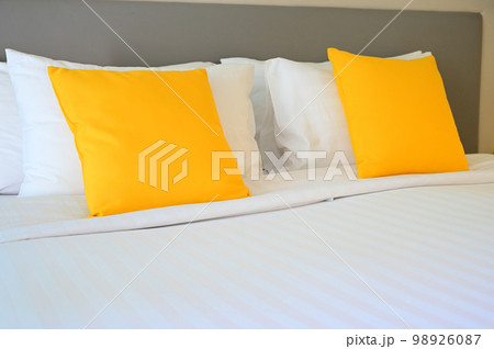 yellow pillow on white bed, interior design 98926087
