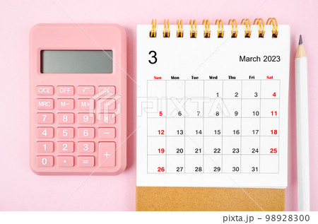 The March 2023 desk calendar for 2023 year with calculator on pink color background. The March 2023 desk calendar for 2023 year with calculator on pink color background. 98928300