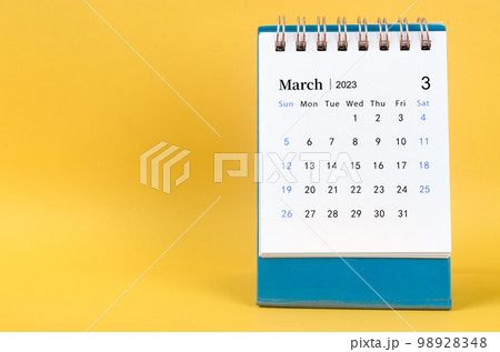March 2023 desk calendar on yellow color background. 98928348