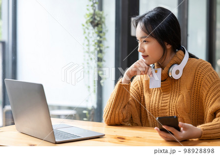Asian woman holding credit card for online shopping and payment makes a purchase on the Internet, Online payment, Business financial and technology Asian woman holding credit card for online shopping and payment makes a purchase on the Internet, Online payment, Business financial and technology 98928898