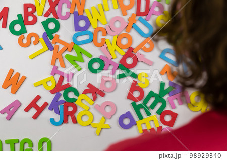 Over the shoulder shot of person looking at alphabet magnets 98929340