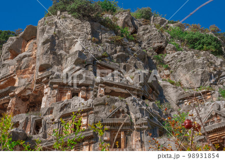 Ruins of Rock-cut tombs in ancient Lycian city of Myra. Lycian way, Demre, Antalya province, Turkey. Ruins of Rock-cut tombs in ancient Lycian city of Myra. Lycian way, Demre, Antalya province, Turkey. 98931854