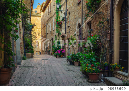 Old stone houses decorated with flowers and green plants, Italy Old stone houses decorated with flowers and green plants, Italy 98933699