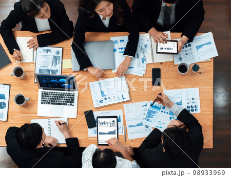Business team of financial data analysis meeting report paper in harmony office. Business team of financial data analysis meeting report paper in harmony office. 98933969