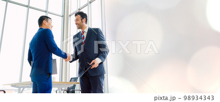 Business people handshake in corporate office in widen view Business people handshake in corporate office in widen view 98934343