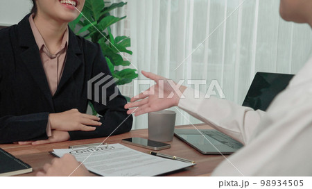Enthusiastic businesswoman handshake after successful business agreement. Enthusiastic businesswoman handshake after successful business agreement. 98934505