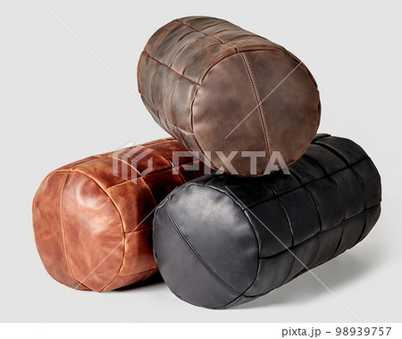 Three comfortable leather bolster cushions in different colors 98939757