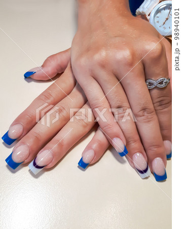 Acrylic nail extension, manicure, nail correction, hands in the foreground. Reflective design. 98940101