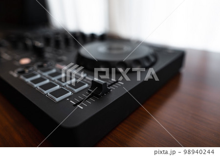 Close-up  dj controller and Sound mixing desk at home 98940244