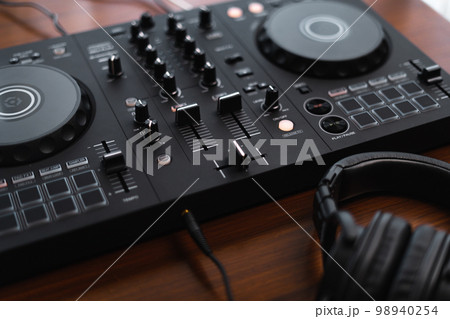 Close-up  dj controller and Sound mixing desk at home 98940254