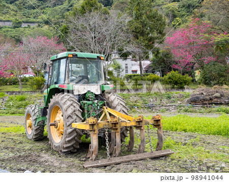 Modern tractor in the agricultural field. 98941044