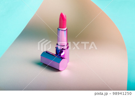 Close up of pink lipstick with purple cap. Cosmetic makeup tool. 98941250