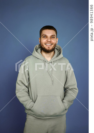 bearded man in sweatshirt on gray background. 98941366