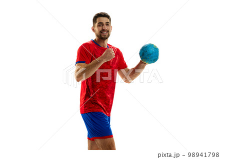 Winner. Portrait of young man, professional handball playing in uniform posing with ball isolated over white studio background. Concept of sport and competition Winner. Portrait of young man, professional handball playing in uniform posing with ball isolated over white studio background. Concept of sport and competition 98941798