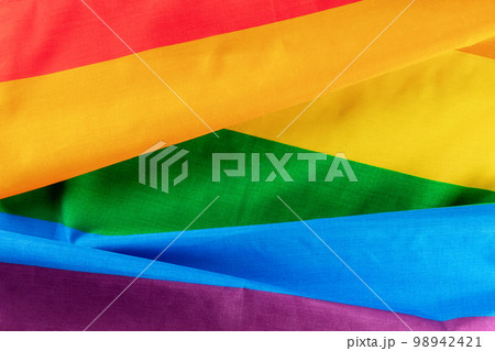 Gay pride flag. LGBTQ rainbow textile texture, overhead flat lay shot Gay pride flag. LGBTQ rainbow textile texture, overhead flat lay shot 98942421