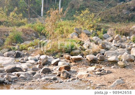 Large Igneous River Boulders and rocks has been carried by the river on the remote mountain place. Rangbang river mountain valley.Tabakoshi West Bengal India Large Igneous River Boulders and rocks has been carried by the river on the remote mountain place. Rangbang river mountain valley.Tabakoshi West Bengal India 98942658