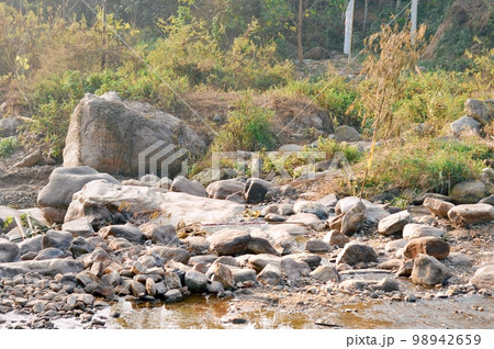 Large Igneous River Boulders and rocks has been carried by the river on the remote mountain place. Rangbang river mountain valley.Tabakoshi West Bengal India Large Igneous River Boulders and rocks has been carried by the river on the remote mountain place. Rangbang river mountain valley.Tabakoshi West Bengal India 98942659
