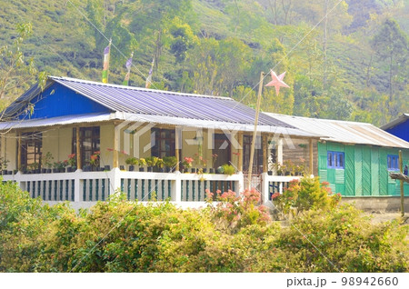 A beautiful wooden hill side cottage on mountain background.Rangbang river mountain valley.Tabakoshi West Bengal IndiaDecember 31, 2022 A beautiful wooden hill side cottage on mountain background.Rangbang river mountain valley.Tabakoshi West Bengal IndiaDecember 31, 2022 98942660