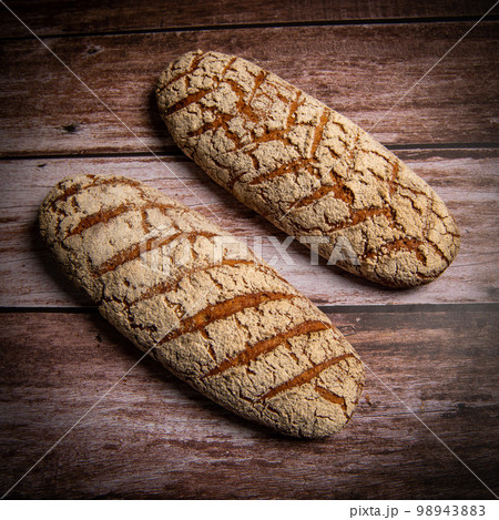 Rye bread on brown background Rye bread on brown background 98943883