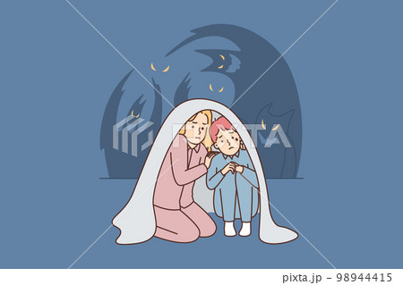 Teenage boy and girl sit wrapped in blanket scared of ghosts after watching scary movie Teenage boy and girl sit wrapped in blanket scared of ghosts after watching scary movie 98944415