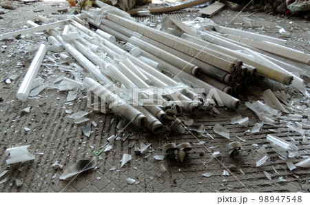 Glass Debris Of Crushed Tube Lamps On Dirty Cement Floor 98947548