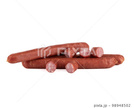 Several whole semi-smoked sausages and slices of thin sausage on a white background. Several whole semi-smoked sausages and slices of thin sausage on a white background. 98948502