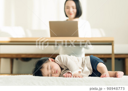 ラグでお昼寝する0歳児の赤ちゃん ラグでお昼寝する0歳児の赤ちゃん 98948773