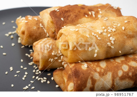 Closeup on dish of foie gras with country style sesame crispy french bread and blini russian pancake isolated on white 98951767
