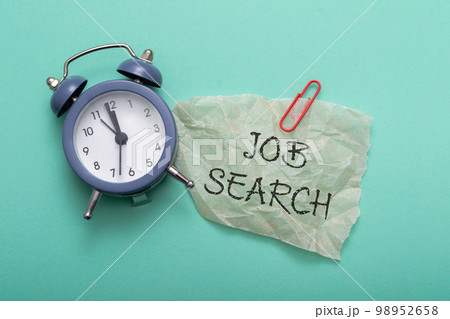 Composition with text Job Search and alarm clock on blue Composition with text Job Search and alarm clock on blue 98952658