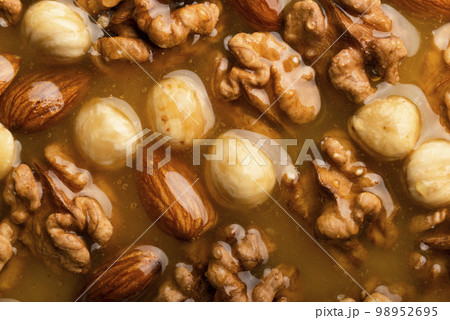 Honeyed assorted nuts organic food background flat view 98952695
