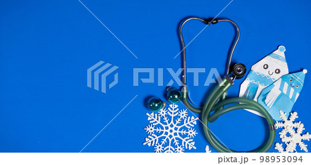 Christmas and New Year Medicine - Stethoscope, Snowmen and Snowflakes on a Blue Background, place for text. 98953094