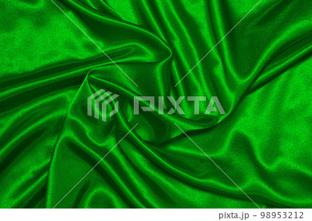 Texture of crumpled green satin fabric, beautiful pattern, top view. 98953212