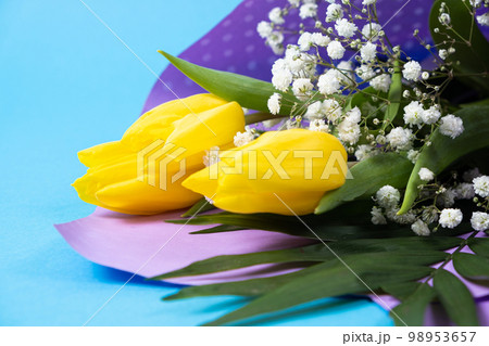 Bouquet of flowers of tulips and gypsophila on a blue background, copy the place for text, hello spring, from March 8 98953657