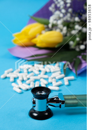 Happy doctor's or nurse's day, medical holiday, card with flowers, pills and stethoscope. 98953658