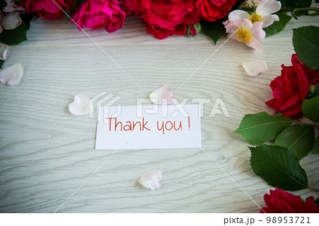 background of many red roses on a light wooden 98953721