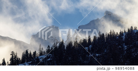 Snow and Cloud covered Canadian Nature Landscape Background 98954088