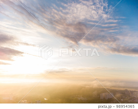 Aerial sunrise sun shine in clouds above city view 98954365